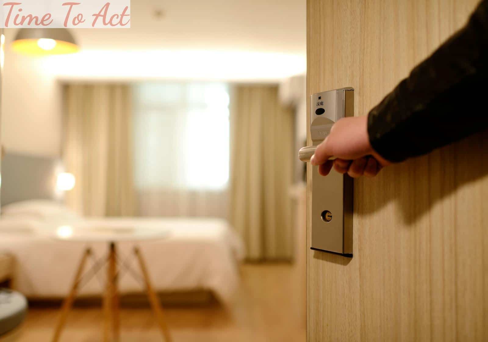 Person Holding on Door Lever Inside Room