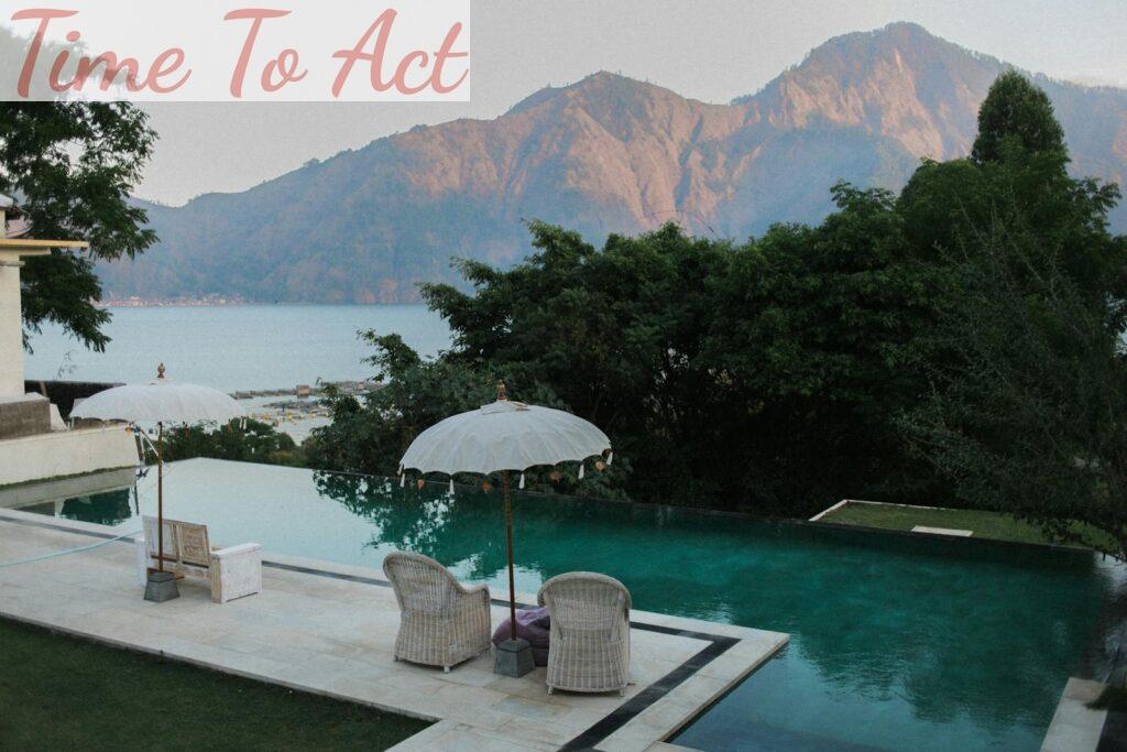 Relax by a serene infinity pool overlooking mountains and the ocean.
