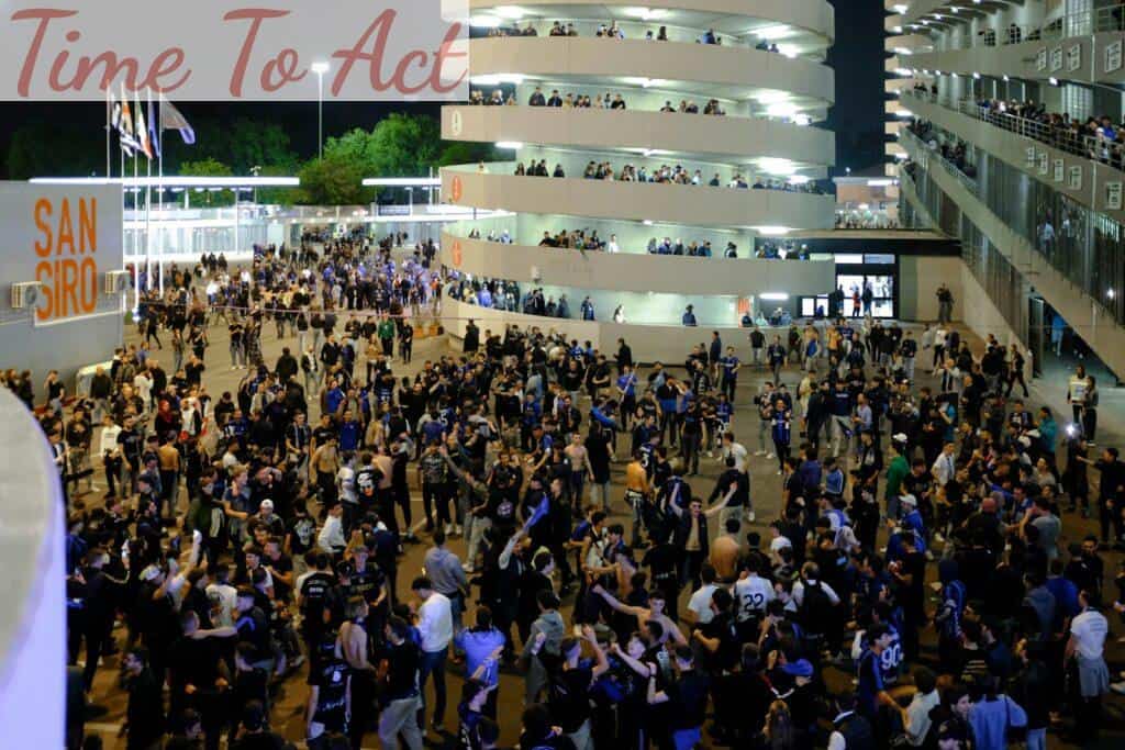 a crowd of people standing around a building at night